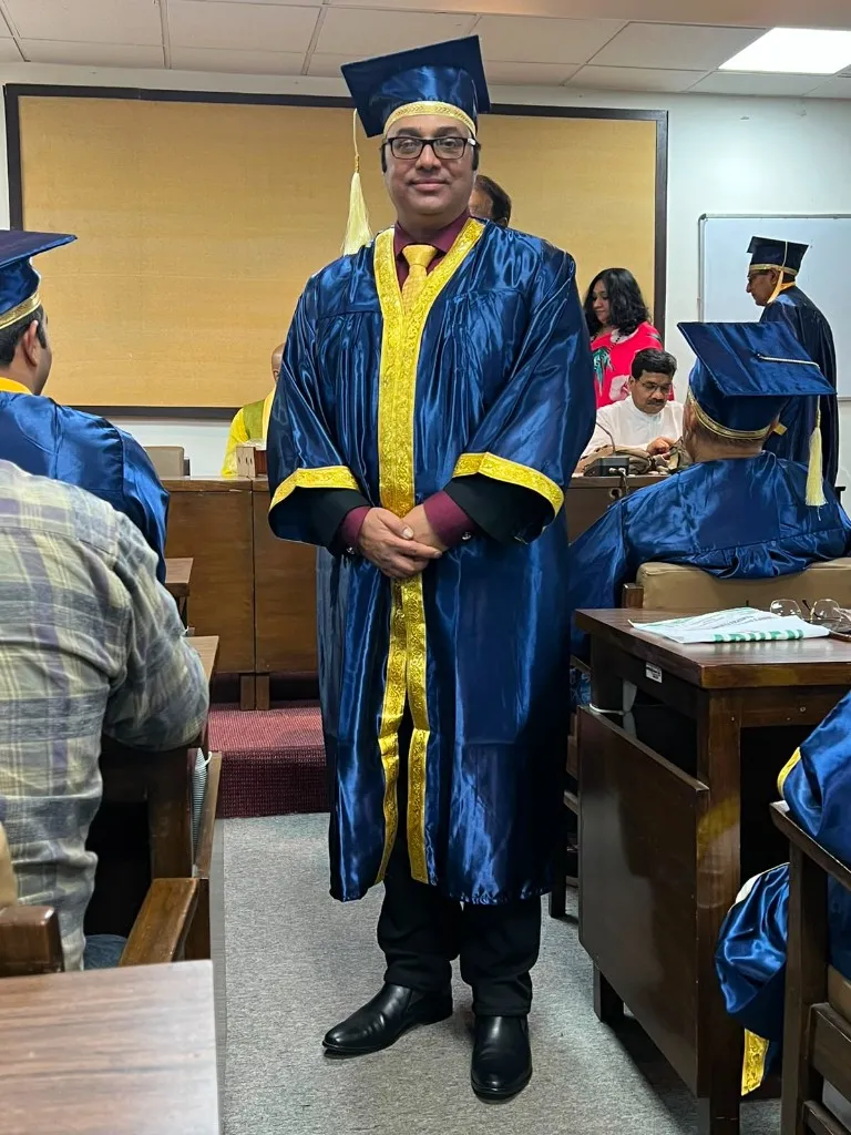 Dr. Anuj Kumar in academic convocation gown at a formal ceremony